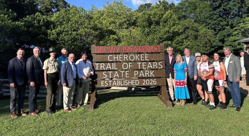 Tennessee State Parks officials, state legislators, Remember the Removal bike riders and tribal partners from The Cherokee Nation and Eastern Band of Cherokee Indians gather near the new sign for Cherokee Trail of Tears State Park at the park’s dedication on June 2, 2026.
