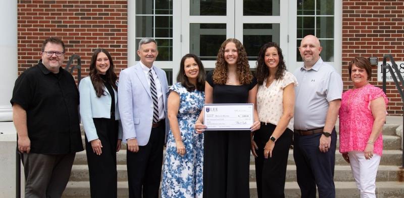 Makayla Broome (center), the inaugural recipient of Lee University's Aspiring Educator of the Year Scholarship, is pictured with her parents and Lee faculty following the scholarship presentation. From left, Dr. Shane Brown, director of teacher education; Micaleah Parker, director of undergraduate admissions; Dr. Bill Estes, dean of the Helen DeVos College of Education; Rachael Pitts, assistant director of teacher education; Ms. Broome; Ashley Broome and Michael Broome, Makayla's parents; and Angela Kersey, a TAP teacher at Bradley Central High School.