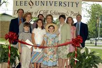 Mary Schimmels (center), with her children and grandchildren, prepares to cut the ribbon. Click to enlarge all our photos.
