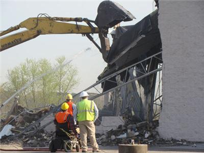 Wall of former Prebul building coming down.