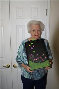 Resident Liz Haynes shows off her floral chalkboard she created in art class.
