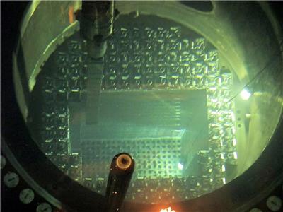 The fuel load team transferring a new assembly from the fuel pool into the reactor