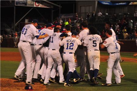 Players mob Jason Wheeler after the third out of the final game.