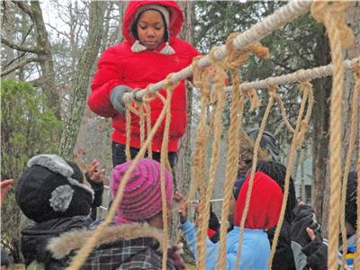 Students from Calvin Donaldson Environmental Science Academy cross a rope bridge they constructed at Nature’s Classroom in Mentone, Al.