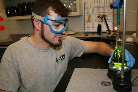 Clayvin Pickard, a GNTC student from Dalton, performs a titration to neutralize an acid in the chemistry lab at the Northwest Georgia College and Career Academy.