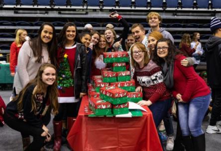 Students from Dr. Sherry Kasper’s Gateway class pose with their Operation Christmas Child shoeboxes during Lee’s annual Pack ‘n’ Stack event