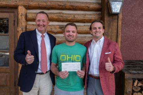 Higher Calling Youth Wrestling Club Head Coach Josh Bosken (center) accepts a check from the Allan Jones Foundation. Pictured with Mr. Bosken are Jones Management Services Vice President J. Bailey Jones (left) and Toby Pendergrass (right), director of the Foundation.