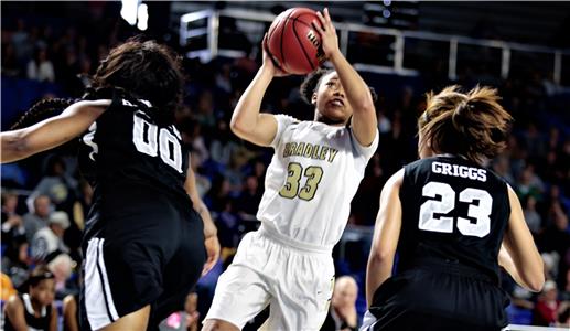 Freshman guard Jamaryn (center) of Bradley Central shoots between Houston's Jayla Hemingay (00) and Madison Griggs in Friday's Class 3A tournament semifinal game at Middle Tennessee State University. Blair scored 13 points, but Houston won the game, 52-49.