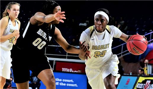 Rhyne Howard of Bradley Central (23) tries to drive around Houston's Jayla Hemingway during their girls state tournament game on Friday. Houston pulled off the upset by beating the previously unbeaten and second-ranked Bearettes, 52-49 in the semifinals. Howard had 25 points and 10 rebounds.