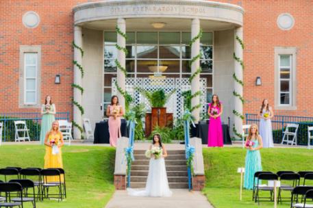 Kshama Patel, in white dress, with May Day court during late July ceremony