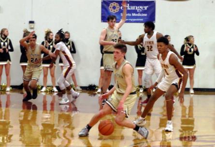 Upperman's Collin Gore works the ball under pressure Monday night at Tyner. The Bees defeated the homestanding Rams and will advance to the Division I State Tournament next week in Murfreesboro. In the other Class AA game involving a Chattanooga team, Howard went on the road and edged York Institute, 56-55, to advance.