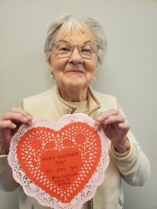 A Legacy Village resident poses with one of the cards