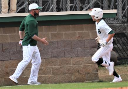 Silverdale head coach Lance Rorex, left, gets ready to congratulate Turner Junkins as he rounds third and heads for home following his third inning homerun in a game against Boyd Buchanan Monday afternoon. The Seahawks defeated the Bucs, 5-1, in the season opener for both teams.