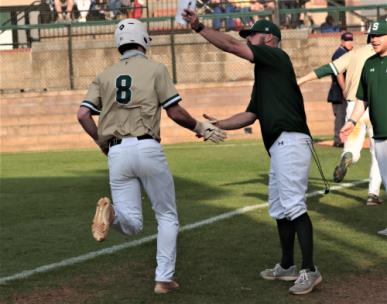 Silverdale's Sebastian Hanks (8) is congratulated by head coach Lance Rorex as he heads for home following his bottom of the seventh walk-off homerun. Hanks' blast pushed the Seahawks to an 8-5 win over CCS Friday evening.