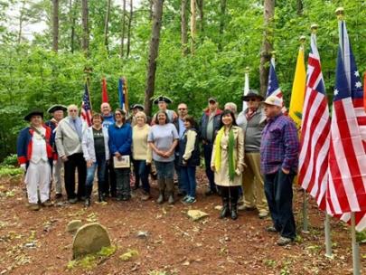 Members of the John Sevier Color Guard in period uniforms, Ladies of the DAR, family members and descendants of Patriot Charles Thurman gather for a photo next to the Patriot’s grave post ceremony at the inactive old Lone Cedar Cemetery, Bledsoe County