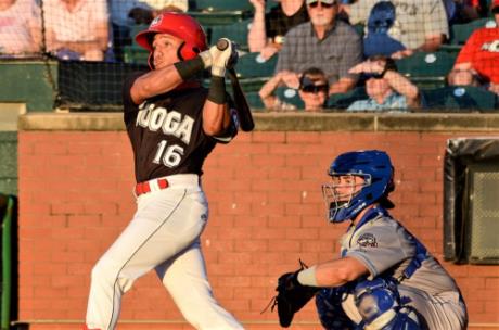 The Lookouts' Brian Rey (16) hits as Rocket City catcher Michael Cruz looks on. Chattanooga won game one of their current series with the Trash Pandas, 5-2.