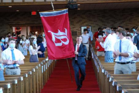 Head of School Chris Angel carried the school flag at the Convocation