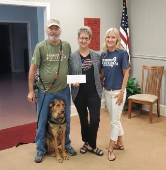 Chattanooga Elks Lodge Exalted Ruler Dawn Whitener presents $1,000 to Wayne Haines and Charlie, graduates of the Warrior Freedom Service Dogs program, and Diane McDermott, development director of Warrior Freedom Service Dogs.

