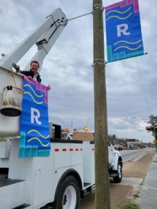 Rossville Mayor Teddy Harris joins the Rossville Public Works department, led by Director Mark Harris, in hanging the city’s new banners