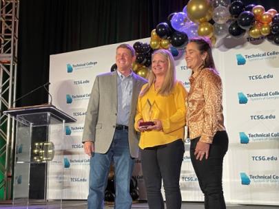 TCSG Commissioner Greg Dozier, left, and 2021 Rick Perkins Award recipient Casey Corbett, right, pose with Crista Resch, GNTC instructor and director of Ultrasound programs, who was selected as one of nine regional finalists for Rick Perkins Instructor of the Year. The winner of the state award will be announced on Wednesday, April 27.
