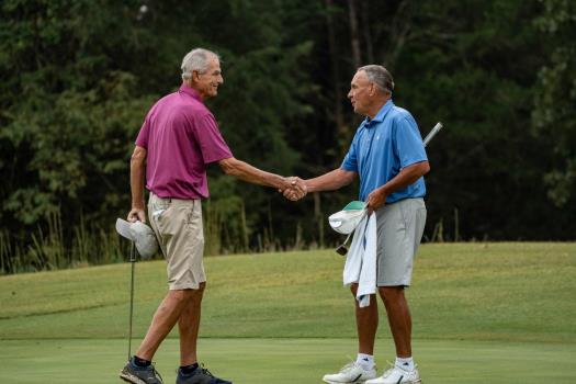 Tom Baird, left, and Fred McCord shake hands at the conclusion of their championship match