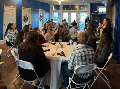 Kristin Pope discusses dining etiquette with students during a recent dinner hosted by the School of Business partnering with local businesses