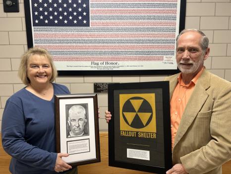 The Allan Jones Foundation donated a framed picture of John Harris Robertson, the first clerk of court for Bradley County, to the Bradley County Courthouse, which will hang in office of Donna Simpson – the current clerk of court for the county. Shown here with Ms. Simpson is County Mayor Gary Davis, holding a framed Fallout Shelter sign donated by Mr. Jones.