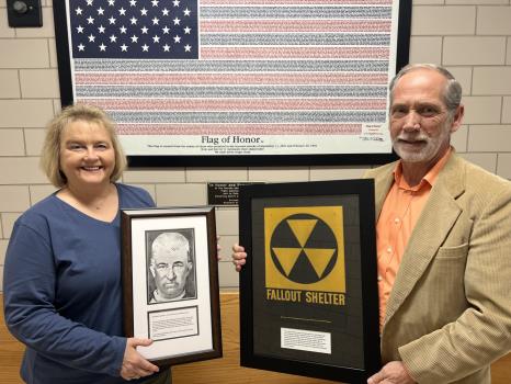 The Allan Jones Foundation donated a framed picture of John Harris Robertson, the first clerk of court for Bradley County, to the Bradley County Courthouse, which will hang in office of Donna Simpson – the current clerk of court for the county. Shown here with Ms. Simpson is County Mayor Gary Davis, holding a framed Fallout Shelter sign donated by Mr. Jones.