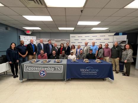 Pictured: (seated, from left to right) Patrick Marshall, Prototype Model Maker apprentice; Bryan Hafley, Industrial Maintenance Repairer apprentice; Courtney Walters, Industrial Maintenance Repairer apprentice; Tre Cannon, Industrial Maintenance Repairer apprentice; Dakota Webb, Industrial Maintenance Repairer apprentice; Canaan Bennett, Industrial Maintenance Repairer apprentice; (standing, from left to right) Laila Malta, Whirlpool senior HR manager; Jeff Jones, Whirlpool senior director of Operations/Production; Mike Mahoney, Whirlpool SmR manager Engineering; Steve Playl, assistant commissioner TN Labor & Workforce Development; John Squires, Cleveland State Community College vice president of Workforce Development, Institutional Research, Advancement, and Communications; Kevin Brooks, mayor of City of Cleveland; Michele Holt, executive director Southeast TN Local Workforce Development Board; Jennifer Thacker, Lead East Regional Apprenticeship director; Jessica Barnett, East Regional Apprenticeship director; Holly Free-Ollard, State of TN Apprenticeship director; Gary Davis, mayor of Bradley County; Tim Kober, Whirlpool Engineering manager for Maintenance & Tooling; Darlene Ownbey, Whirlpool senior analyst Training/People Development; Mike Griffin, director of Cleveland Chamber & CSCC Foundation chair; Wesley Glover, Whirlpool Model Shop supervisor; and Heather Brown, Cleveland State director of Workforce Development.