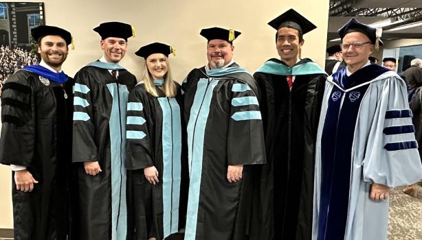Lee HDCOE faculty with the EdD graduates, from left to right, Dr. Jesse Wood, Dr. Joe Parker, Dr. Kristen Early, Dr. Allen Clark, Dr. Roy Chan, and Dr. Bill Estes