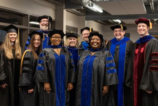 From left, MFT graduates with Lee Behavioral and Social Sciences faculty (back) Dr. Julie Gardenhire, Dr. Joel Lyon, Dr. Trevor Milliron, Dr. Edward Stone, and Dr. Brandon Rodgers, (front) Dr. Kirstee Williams, Dr. Danielle Gray, Dr. Heather Quagliana, and Dr. Eboni Long.
