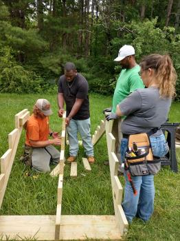 Pictured, left to right: Instructor Brad Laxton, Jalen Hickey, Dante Hickey and Patricia Vaughn build the Cleveland State Law Enforcement Academy physical ability course steps