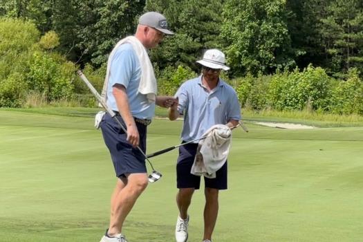 Whit Turnbow, left, congratulates Payne Denman after a birdie putt on No. 11 at the Tennessee State Four-Ball