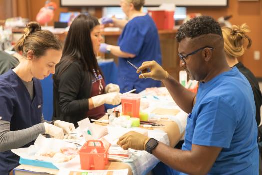 Current DNP-FNP students practicing suturing in the skills lab during the preview event, hosted at Lee’s School of Nursing