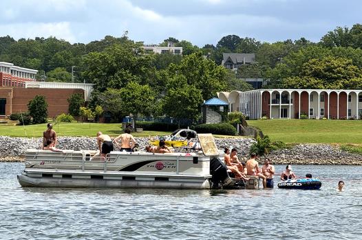 Boaters take a break on the Tennessee River near the Walnut Street Bridge and Maclellan Island.