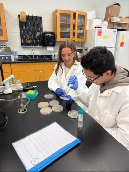Lee University cell and molecular biology lab students Ashtyn Stock, left, and Lucas Quezada work with TChen genes